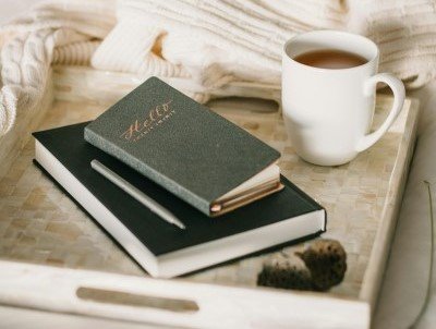 EZE+ Journal books on table with coffee
